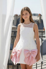 فستان بنات بلون الكريمي مع فيونكة لؤلؤية للأعمار من 8 إلى 14 سنة